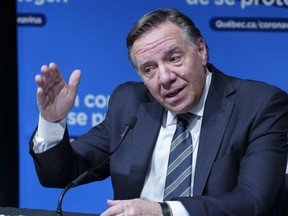 Quebec Premier Francois Legault responds to a question during a news conference in Montreal, on Thursday, December 16, 2021. A group of Canadian technology companies is calling on the Quebec premier to pause a bill requiring immigrants to learn French within six months of arriving in the province.
