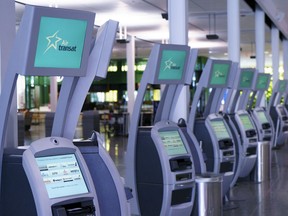 Air Transat self service check-in kiosks are seen at Montreal-Trudeau International Airport in Montreal, on Friday, July 31, 2020. Transat A.T. Inc. reported its second-quarter loss grew compared with a year ago, as it worked to capitalize on a recovery in the travel business.