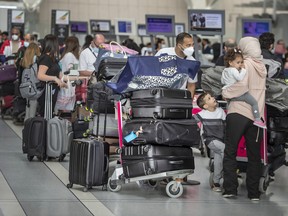 Travellers wait in a line at Toronto's Pearson airport in May.
