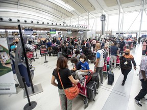 Travellers wait in line at Toronto Pearson Airport in May.
