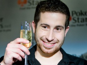 Jonathan Duhamel, first Canadian winner of the World Series of Poker, celebrates at a press conference in Toronto in 2010.