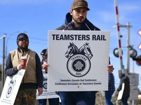 Canadian Pacific Railway workers picket in Calgary on March 20, 2022.