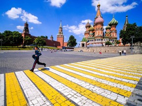 A Russian officer crosses the square in front of Saint Basil's Cathedral near The Kremlin in Moscow, on June 25, 2022.