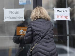 A customer enters a restaurant with help wanted signs Wednesday, November 17, 2021 in Laval, Que. Statistics Canada says the number of job vacancies at the beginning of April hit just over one million, up more than 40 per cent compared with a year earlier.