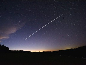 This long-exposure file image shows the trail of a group of satellites passing over Uruguay.