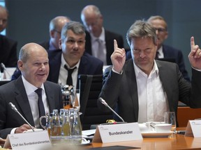 German Economy and Climate Minister Robert Habeck, front right, point up as German Chancellor Olaf Scholz, front left, opens the 'Alliance For Transformation' summit at the Chancellery in Berlin, Germany, Tuesday, June 14, 2022.