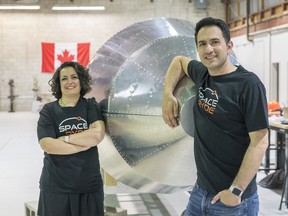 Saharnaz Safari, left, and Sohrab Haghighat, right, pose with their rocket at SpaceRyde in Concord, Ont.