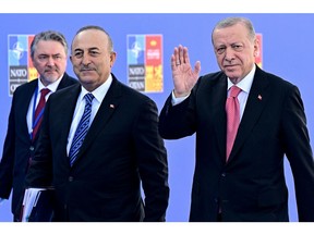 Turkey's President Recep Tayyip Erdogan (R) and Turkey's Minister for Foreign Affairs Mevlut Cavusoglu arrive for the NATO summit at the Ifema congress centre in Madrid, on June 29, 2022.  Photographer: Javier Soriano/AFP/Getty Images