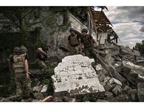 Ukrainian soldiers inspect a destroyed warehouse reportedly targeted by Russian troops on outskirts of Lysychansk, in the eastern Ukrainian region of Donbas on June 17, 2022 Photographer: Aris Messinis/AFP/Getty Images