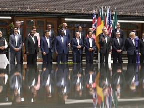 U.S. President Joe Biden, front fourth right, waves as he poses with G7 leaders and Outreach guests for an official group photo at Castle Elmau in Kruen, near Garmisch-Partenkirchen, Germany, on Monday, June 27, 2022. The Group of Seven leading economic powers are meeting in Germany for their annual gathering Sunday through Tuesday.