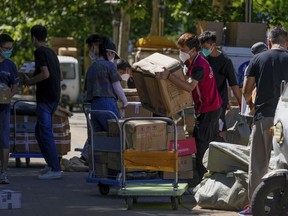 Workers of a private delivery company sort out parcels piled up at a pickup point in Beijing on June 5, 2022. China's trade growth rebounded in May after anti-virus restrictions that shut down Shanghai and other industrial centers began to ease, according to a customs agency statement on Thursday, June 9.