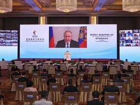 In this photo released by Xinhua News Agency, Russian President Vladimir Putin delivers a keynote speech in virtual format at the opening ceremony of the BRICS Business Forum in Beijing Wednesday, June 22, 2022. The conflict in Ukraine has "sounded an alarm for humanity," Chinese leader Xi Jinping said Wednesday, as China continues to assume a position of neutrality while backing its ally Russia.