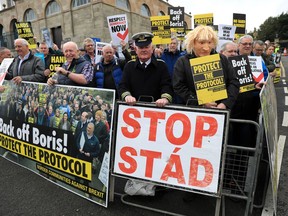 FILE - Demonstrators protest outside Hillsborough Castle, ahead of a visit by British Prime Minister Boris Johnson, in Hillsborough, Northern Ireland, Monday, May, 16, 2022. Britain is pressing on with a plan to rip up parts of the post-Brexit trade deal it signed with the bloc European Union. Legislation that rewrites trade rules for Northern Ireland is scheduled to get its first major House of Commons debate on Monday, June 27, 2022.