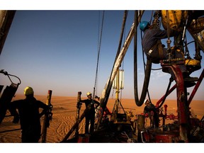 A Repsol Oil Operations oil drilling rig pounds into the desert searching through thousands of feet for and oil reserve on June 5, 2004 in El-Sharara, Libya. Photographer: Benjamin Lowy/Getty Images