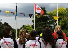 Team Canada athletes participating in the 2022 Birmingham Games look up at the Canadian flag as it is raised during the flag raising ceremony. Photo credits: DetailsGroup