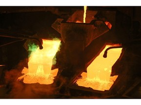 Molten copper flows into rotating molds during the production of copper cathode sheets in the copper smelting shop at the Uralelectromed OJSC Copper Refinery, operated by Ural Mining and Metallurgical Co. (UMMC), in Verkhnyaya Pyshma, Russia, on Tuesday, March 7, 2017. Russia's No. 1 zinc miner and No. 2 copper producer plans a far-reaching expansion of its diversified minerals output, billionaire co-owner and Chief Executive Officer Andrey Kozitsyn said in an interview.