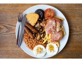 The 'Super' full English breakfast sits at the 'Enough to Feed an Elephant' cafe in this arranged photograph in London, U.K., on Monday, July 10, 2017. British consumers could see the price of a fry-up -- a classic English breakfast with ingredients like bacon, sausages, orange juice, baked beans and mushrooms -- increase by almost 13 percent.