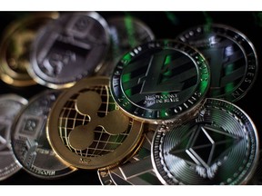 LONDON, ENGLAND - APRIL 25: In this photo illustration of the litecoin, ripple and ethereum cryptocurrency 'altcoins' sit arranged for a photograph on April 25, 2018 in London, England. Cryptocurrency markets began to recover this month following a massive crash during the first quarter of 2018, seeing more than $550 billion wiped from the total market capitalisation.