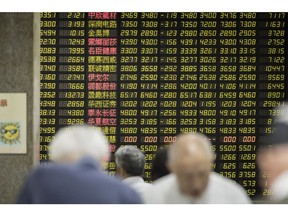 Investors stand in front of an electronic stock board at a securities brokerage in Shanghai, China, on Wednesday, May 30, 2018. Foreign investors are about to get a bargain. At least, that's the optimistic slant after Chinese equities slumped for the longest stretch since 2013, taking valuations back to two-year lows right before they feature on MSCI Inc. indexes from June 1. Photographer: Qilai Shen/Bloomberg