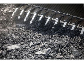 A front loader moves coal at the Tori Siding on the Tori-Shivpur rail line, operated by Indian Railways and funded by Coal India Ltd., in Chandwa, Jharkhand, India, on Thursday, May 17, 2018. State miner Coal India's output and shipments jumped to seasonal records in June, buoyed by summer demand from power stations, the company's biggest customers. Photographer: Prashanth Vishwanathan/Bloomberg
