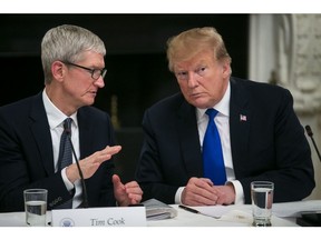 Tim Cook speaks with President Donald Trump during an American Workforce Policy Advisory board meeting in Washington in March 2019. Photographer: Al Drago/Bloomberg
