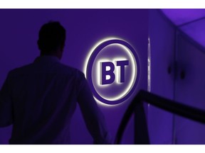 An attendee passes a BT Group Plc logo during a news conference in London, U.K., on Wednesday, Oct. 9, 2019. BT is making a new push to improve customer service, including the arrival of BT-branded shops for the first time in almost two decades, as Chief Executive Officer Philip Jansen begins a charm offensive to defend market share. Photographer: Hollie Adams/Bloomberg