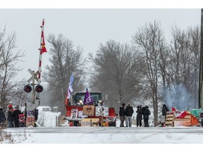 Demonstrators stand near railway tracks during a protest near Belleville, Ontario, Canada, on Thursday, Feb. 13, 2020. Demonstrators have been disrupting railroads and other infrastructure across Canada for more than a week to protest TC Energy Corp.'s planned C$6.6 billion ($5 billion) Coastal GasLink pipeline.