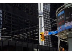 Financial news is seen on a screen in the financial district of Toronto, Ontario, Canada, on Monday, March 16, 2020. Canadian stocks plunged more than 9% after emergency measures from central banks failed to soothe fears the economy will suffer a heavy blow from the coronavirus. Photographer: Cole Burston/Bloomberg