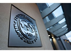 Signage hangs at the International Monetary Fund (IMF) headquarters in Washington, D.C., U.S., on Tuesday, April 14, 2020. In its first World Economic Outlook report since the spread of the coronavirus and subsequent freezing of major economies, the IMF estimated today that global gross domestic product will shrink 3% this year. Photographer: Andrew Harrer/Bloomberg