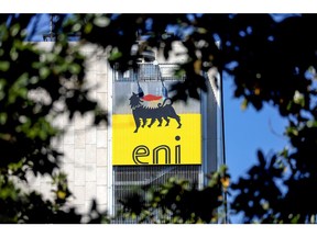 The ENI SpA logo sits on the company's headquarters office building seen through trees in Rome, Italy, on Friday, April 24, 2020. Eni SpA reported a 94% drop in first-quarter profit and cut its production forecast for the year as demand is crushed by the coronavirus pandemic.