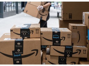 Amazon.com packages are stacked on the sidewalk in New York.
