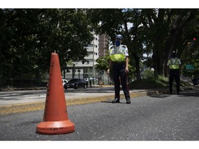 CARACAS, VENEZUELA - JULY 06: Police officers control the entrance of the Francisco Miranda Avenue in Los Palos Grandes on July 6, 2020 in Caracas, Venezuela. Venezuela resumes today a total lockdown after a week of easing measures. The country will apply a so-called "7x7 plan" which includes a week of confinement and a week of flexibility.
