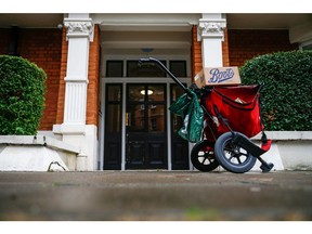 A Royal Mail Plc trolley on a street outside a residential address in London, U.K., on Thursday, Oct. 08, 2020. Covid-19 lockdown enabled online and app-based grocery delivery service providers to make inroads with customers they had previously struggled to recruit, according the Consumer Radar report by BloombergNEF.