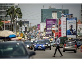 Vehicles drive along a road in Accra, Ghana, Tuesday, Oct. 23, 2020. Ghana misses an African bond rally as investors worry about increased spending and borrowing ahead of elections in december.  Photographer: Cristina Aldehuela/Bloomberg