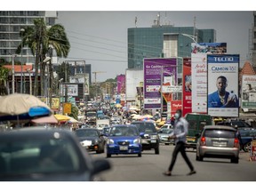 Vehicles drive along a road in Accra, Ghana, Tuesday, Oct. 23, 2020. Ghana misses an African bond rally as investors worry about increased spending and borrowing ahead of elections in december. Photographer: Cristina Aldehuela/Bloomberg