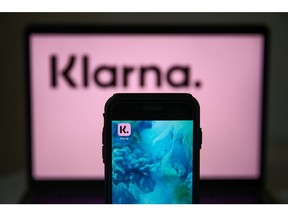 A Klarna logo on a laptop and mobile phone arranged in London, U.K., on Thursday, Jan. 21, 2021. Klarna AB, a Swedish payment provider for online shoppers, is still setting its sights on an initial public offering even after its latest funding round left it roughly twice as valuable as it was a year ago.