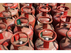 Indian Oil Corp. Indane brand liquefied petroleum gas (LPG) cylinders at a village warehouse in Greater Noida, Uttar Pradesh, India, on Monday, Feb. 22, 2021. Provisions for LPG cooking fuel subsidies, launched in 2016 by the Modi government offering cash rebates for purchasing an LPG connection and a loan for the first canister of the fuel and stove, were halved in the federal budget for the fiscal year ending March 2022 to 124.8 billion rupees ($1.7 billion) from 255 billion rupees a year earlier. Photographer: T. Narayan/Bloomberg