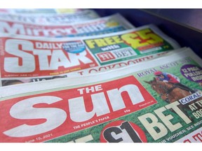 Copies of The Sun newspaper, alongside other tabloid titles, inside a newsagent in London, U.K., on Tuesday, June 15, 2021. Rupert Murdoch's News Corp. wrote down the value of its once high-flying Sun title to zero, underscoring the dramatic decline in Britain's newspaper industry.