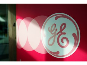 The logo of General Electric can be seen on a banner at Plant 23 in the GE Aviation Service Operation LLP facility in Singapore, on Monday, Nov. 22. 2021. Photographer: Ore Huiying/Bloomberg