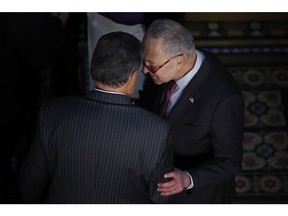 Sen. Joe Manchin (D-WV) (L) talks with Senate Majority Leader Charles Schumer (D-NY) before the ceremony where U.S. President Joe Biden signed the "Consolidated Appropriations Act" in the Eisenhower Executive Office Building on March 15, 2022 in Washington, D.C.