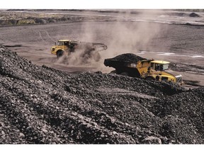 Trucks move coal tailings around a dump site at a coal mine in Knurow, Poland, on April 13. Photographer: Bartek Sadowski/Bloomberg