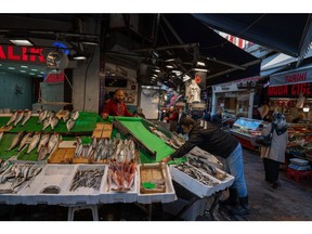 A vendor arranges a display at a fishmonger's stall in Istanbul, Turkey on Thursday, April 21, 2022. Turkish inflation soared to a fresh two-decade high in March, leaving the lira increasingly vulnerable by depriving the currency of a buffer against market selloffs. Photographer: Erhan Demirtas/Bloomberg