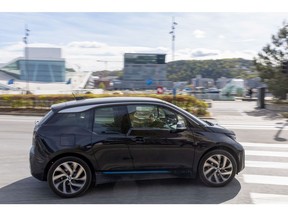 An electric vehicle (EV) passes the Opera House in Oslo, Norway, on Thursday, May 5, 2022. Norway's central bank confirmed its plan to deliver a fourth increase in borrowing costs next month and repeated its warning of faster hikes if needed to quell inflation.