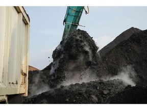 An excavator loads coal onto a dump truck at Cirebon Port in West Java, Indonesia, on Wednesday, May 11, 2022. Trade has been a bright spot for Indonesia, which has served as a key exporter of coal, palm oil and minerals amid a global shortage in commodities after Russia's invasion of Ukraine.