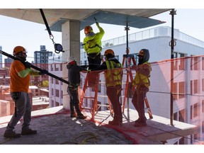 Contractors work at a commercial development under construction in Brooklyn, New York.
