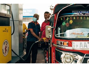 A three wheeler vehicle gets petrol pumped at a petrol station near the High Level Road in Colombo, Sri Lanka, on Sunday, May 22, 2022. Sri Lanka's dollar bonds due July rebound after Friday's drop, up almost 5 cents on the dollar in the biggest gain since October, as the government holds bailout talks with the IMF.