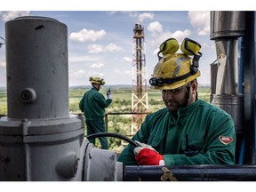Workers on an oil storage tank at the Duna oil refinery, operated by MOL Hungarian Oil & Gas Plc, in Szazhalombatta, Hungary, on Thursday, May 26, 2022. Hungarian Prime Minister Viktor Orban said there was no consensus among European Union leaders on banning Russian oil but signaled he was ready to agree if the bloc guarantees his country still receives the fuel via a pipeline and other measures in case that avenue is disrupted. Photographer: Akos Stiller/Bloomberg
