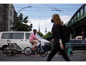 A cyclist and motorists at a road junction in Berlin, Germany, on Wednesday, June 1, 2022. To reduce its heavy reliance on Russian gas and oil after Russia's invasion of Ukraine, Germany has slashed the cost of public transit to just 9 euros ($9.56) a month -- from today for the summer -- for all subways, buses, trams and regional trains.