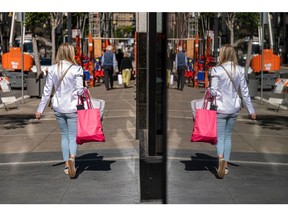 A pedestrian carries shopping bags in San Francisco, California, US, on Wednesday, June 1, 2022. US consumer confidence dropped in May to the lowest since February, underscoring the impact of decades-high inflation on Americans economic views.