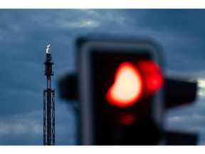 A flare stack releases flammable gases at a plant in the Leuna refinery and chemical industrial complex, home to facilities operated by companies including TotalEnergies SE, Shell Plc, BASF SE, and Linde AG, beyond a traffic signal in Leuna, Germany, on Tuesday, June 7, 2022. TotalEnergies' 240,000 barrels per day Leuna refinery is set to cease importing Russian crude oil via the Druzhba pipeline some time later this year. Photographer: Krisztian Bocsi/Bloomberg